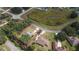 Aerial view of property showcasing landscaping, nearby pond, and neighborhood at 5005 County Road 125B1, Wildwood, FL 34785