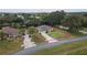 Aerial view of a lovely single-story home with a lush green yard and an extra long driveway at 5005 County Road 125B1, Wildwood, FL 34785