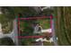 Aerial view of a home nestled among the trees with a long drive and plenty of yard at 5005 County Road 125B1, Wildwood, FL 34785