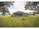Spacious backyard featuring a built-in fire pit and mature trees at 5005 County Road 125B1, Wildwood, FL 34785