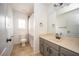 Bathroom with gray vanity, large mirror, and shower with curtain at 5005 County Road 125B1, Wildwood, FL 34785