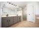 Bathroom with double vanity, glass-enclosed shower, and tile flooring at 5005 County Road 125B1, Wildwood, FL 34785