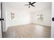 Spacious bedroom with modern ceiling fan and light wood-look floors at 5005 County Road 125B1, Wildwood, FL 34785