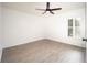 Bright bedroom with ceiling fan and light wood-look flooring at 5005 County Road 125B1, Wildwood, FL 34785