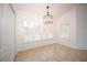 Bright dining area with tile flooring, plantation shutters, and an elegant chandelier at 5005 County Road 125B1, Wildwood, FL 34785