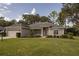 Charming single-story home with well-manicured lawn and landscaping at 5005 County Road 125B1, Wildwood, FL 34785