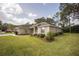 Charming single-story home with well-manicured lawn and mature landscaping at 5005 County Road 125B1, Wildwood, FL 34785