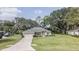 Inviting single-story home with a lush lawn, mature trees, and a convenient two-car garage at 5005 County Road 125B1, Wildwood, FL 34785