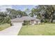 Attractive single-story home featuring a two-car garage and a well-kept lawn at 5005 County Road 125B1, Wildwood, FL 34785