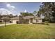 Charming single-story home with a well-manicured lawn and beautiful landscaping at 5005 County Road 125B1, Wildwood, FL 34785