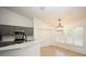 Modern kitchen featuring gray cabinets, stainless steel appliances, and a breakfast bar overlooking the dining area at 5005 County Road 125B1, Wildwood, FL 34785