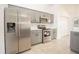 Kitchen with gray cabinets, stainless steel appliances, and tile flooring at 5005 County Road 125B1, Wildwood, FL 34785