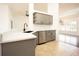 Contemporary kitchen featuring gray cabinets, quartz countertops and stainless steel appliances at 5005 County Road 125B1, Wildwood, FL 34785