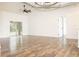 Spacious living room with vaulted ceiling, ceiling fan, and sliding glass doors at 5005 County Road 125B1, Wildwood, FL 34785