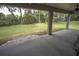 Covered patio overlooking a grassy backyard, surrounded by mature trees at 5005 County Road 125B1, Wildwood, FL 34785