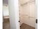 Walk-in closet with custom shelving and rods for optimal storage at 5005 County Road 125B1, Wildwood, FL 34785