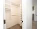 Walk-in closet with custom shelving and rods for optimal storage at 5005 County Road 125B1, Wildwood, FL 34785
