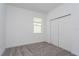 Bedroom features a window, closet and plush gray carpeting at 5033 Balsam Falls Rd, Deland, FL 32724