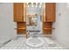 Bright bathroom with vanity, tile countertop, and ample lighting at 550 Floral Dr, Kissimmee, FL 34743