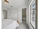Bright bedroom with large windows, closet space and ensuite bathroom featuring black and white pattern tile at 550 Floral Dr, Kissimmee, FL 34743