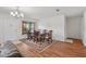Well-lit dining area featuring hardwood floors, chandelier, and neutral paint, next to the living space at 550 Floral Dr, Kissimmee, FL 34743