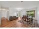 Bright dining area with hardwood floors, chandelier, and neutral paint, adjacent to the living area at 550 Floral Dr, Kissimmee, FL 34743
