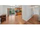 Open kitchen area with wood cabinets, light countertops, and a view of the outdoor patio at 550 Floral Dr, Kissimmee, FL 34743