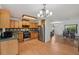 Functional kitchen featuring wood cabinetry, stainless steel appliances, and adjacent dining space at 550 Floral Dr, Kissimmee, FL 34743