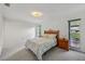 Cozy main bedroom with floral bedding and view to balcony and backyard at 550 Floral Dr, Kissimmee, FL 34743
