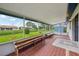 Relaxing screened patio with tile floor and bench seating overlooking a well-maintained backyard at 550 Floral Dr, Kissimmee, FL 34743
