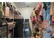 Organized walk-in closet with shelving and hanging racks, providing ample storage space at 6001 Pine Bluff Ln, Mascotte, FL 34753