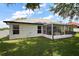 Exterior view showcasing a screened patio and backyard, great for outdoor enjoyment at 6001 Pine Bluff Ln, Mascotte, FL 34753