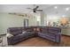 Open-concept living room featuring a large sectional sofa, tile flooring, and neutral walls and decor at 6001 Pine Bluff Ln, Mascotte, FL 34753