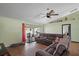 Comfortable living room featuring a large sectional sofa and sliding glass doors to the outdoor area at 6001 Pine Bluff Ln, Mascotte, FL 34753