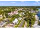 Aerial view showcasing a neighborhood with modern homes, a condo building and railway tracks surrounded by lush greenery at 601 N Mcdonald St # 2, Mount Dora, FL 32757