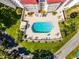 Aerial view of the community pool surrounded by lush landscaping and manicured grounds at 601 N Mcdonald St # 2, Mount Dora, FL 32757