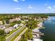 Overhead shot shows varied roofs, water, lush trees and a waterfront community, giving an overview of the area's geography at 601 N Mcdonald St # 2, Mount Dora, FL 32757