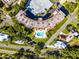 Aerial view featuring the building's architecture, community pool, and surrounding greenery at 601 N Mcdonald St # 2, Mount Dora, FL 32757