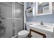 Bathroom featuring a glass shower enclosure, commode, and modern white vanity, providing a clean and sleek look at 601 N Mcdonald St # 2, Mount Dora, FL 32757