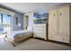 Cozy bedroom featuring a murphy bed and built in shelving and cabinets at 601 N Mcdonald St # 2, Mount Dora, FL 32757