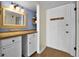 Inviting entryway featuring wood floors, updated vanity, and ample storage with a well-lit space at 601 N Mcdonald St # 2, Mount Dora, FL 32757