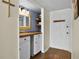 Inviting entryway featuring wood floors, updated vanity, and ample storage with a well-lit space at 601 N Mcdonald St # 2, Mount Dora, FL 32757