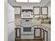 Efficient kitchen with white appliances, ample counter space, and white paneled cabinets at 601 N Mcdonald St # 2, Mount Dora, FL 32757