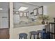 Compact kitchen featuring white cabinets, modern appliances, and a breakfast bar with seating at 601 N Mcdonald St # 2, Mount Dora, FL 32757