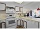 Bright kitchen with white appliances, wood-trimmed cabinets, and a breakfast bar at 601 N Mcdonald St # 2, Mount Dora, FL 32757