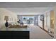 Light-filled living room with neutral decor, a comfortable seating area, and sliding doors to the balcony at 601 N Mcdonald St # 2, Mount Dora, FL 32757