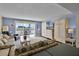 Bright living room with a wall-mounted TV, a Murphy bed, and access to a balcony at 601 N Mcdonald St # 2, Mount Dora, FL 32757