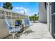 Outdoor patio area featuring two outdoor chairs and a view of the community pool at 601 N Mcdonald St # 2, Mount Dora, FL 32757
