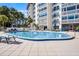 Beautiful community pool featuring many lounge chairs perfect for entertaining and relaxing on a warm day at 601 N Mcdonald St # 2, Mount Dora, FL 32757