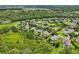 An aerial perspective of a peaceful neighborhood featuring mature trees and carefully manicured lawns at 6048 Tremayne Dr, Mount Dora, FL 32757